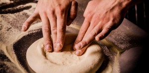 Chef shaping fresh pizza dough by hand at Vesu Pizza Bar in Tsim Sha Tsui, Hong Kong.